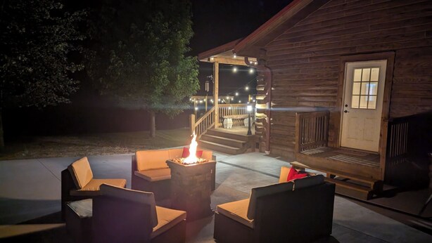 A wooden cabin with a fire pit and outdoor seating area. - Remote and quiet! (English)