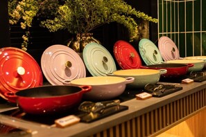 A kitchen counter with various cookware and utensils.
