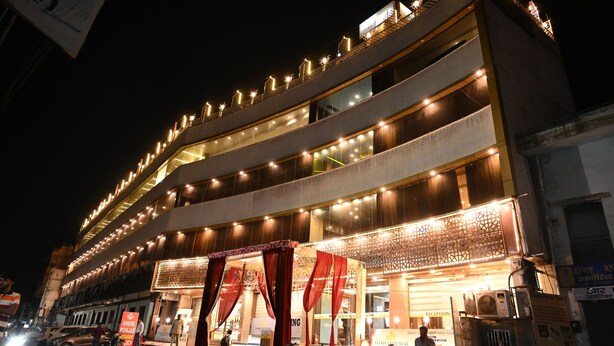 A multi-story hotel with a reception area, multiple floors, and a well-lit facade. - The Shah Imperial (Gwalior)