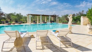 A pool area with lounge chairs, a pergola, and a statue. - Villa La Dolce Vita 6 Emma Villas (Oria)