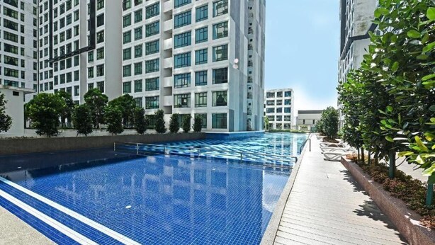 A modern residential building with a swimming pool and a wooden deck. - D'Summit Residences by YML Homestay (Johor Bahru)
