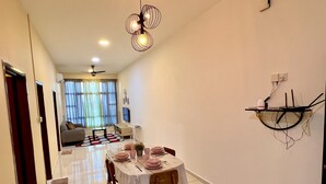 A dining area with a table set for four, a ceiling fan, and a wall-mounted shelf with cables. - D'Summit Residences by YML Homestay (Johor Bahru)