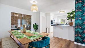 A modern kitchen with white cabinets, a black countertop, and a hanging plant. - Clearwater Villa / Heated Pool, Hot Tub, Golf! (Clearwater)