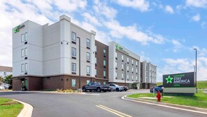 A multi-story hotel with a modern design, featuring a prominent sign for Extended Stay America suites.