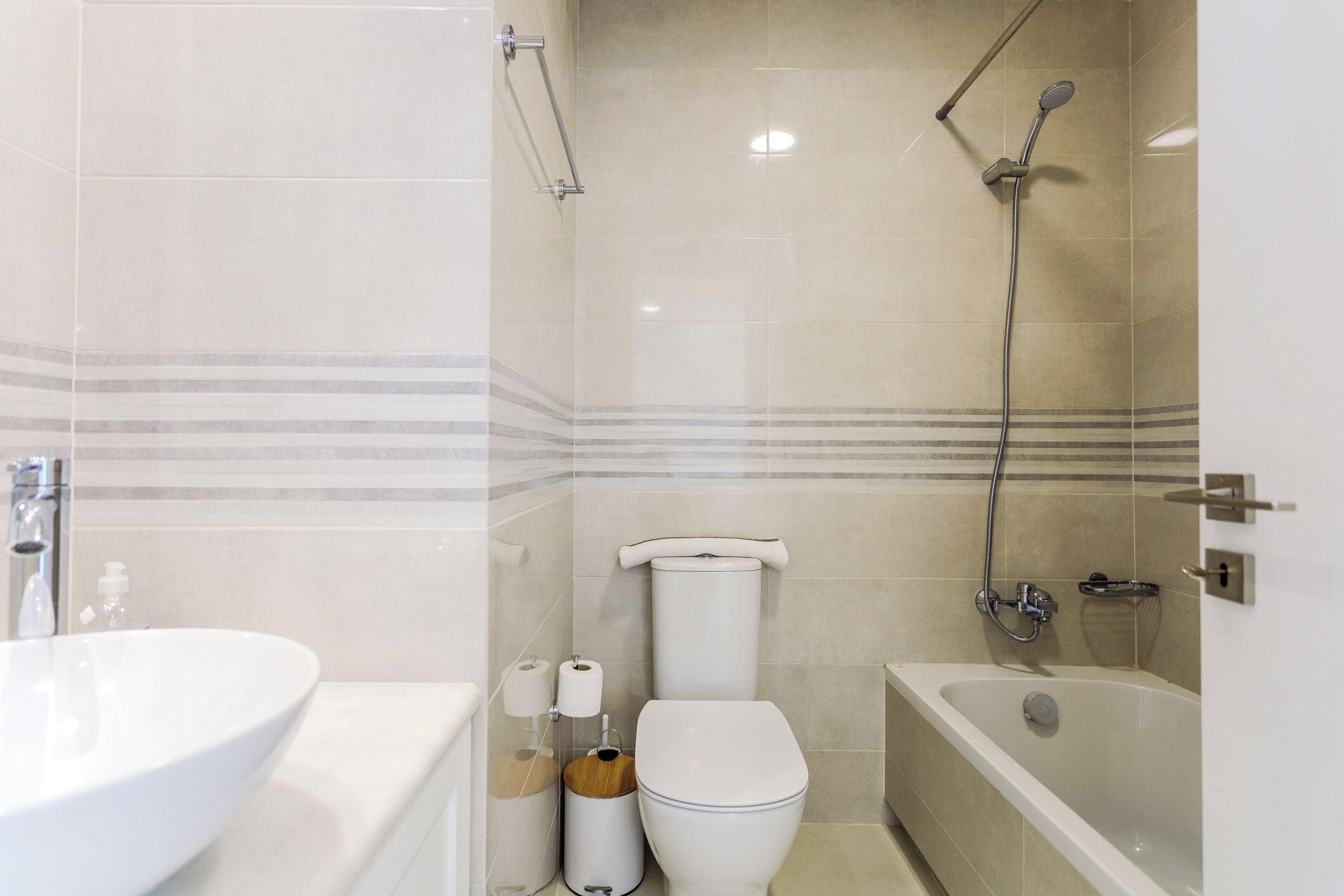 A bathroom with a sink, toilet, bathtub, and shower.