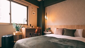 A hotel room with a bed, a desk, a chair, a suitcase, and a window. - R Hotel-The Atelier Shinsaibashi East (Osaka)
