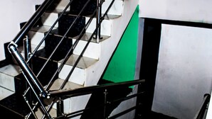 A staircase with black metal railings and white steps. - j14 hotel and suites (Lagos)