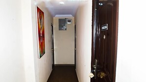 A narrow hallway with a door labeled "CHELSEA" on the right. - j14 hotel and suites (Lagos)