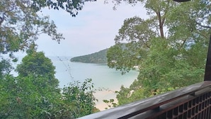 A view from a balcony overlooking a calm body of water, surrounded by lush greenery. - Villa Hutan Datai (Langkawi)