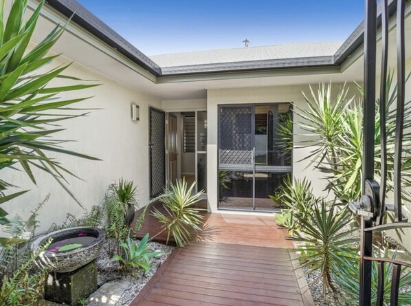 Enjoy the serene garden and expansive views from the wooden deck.