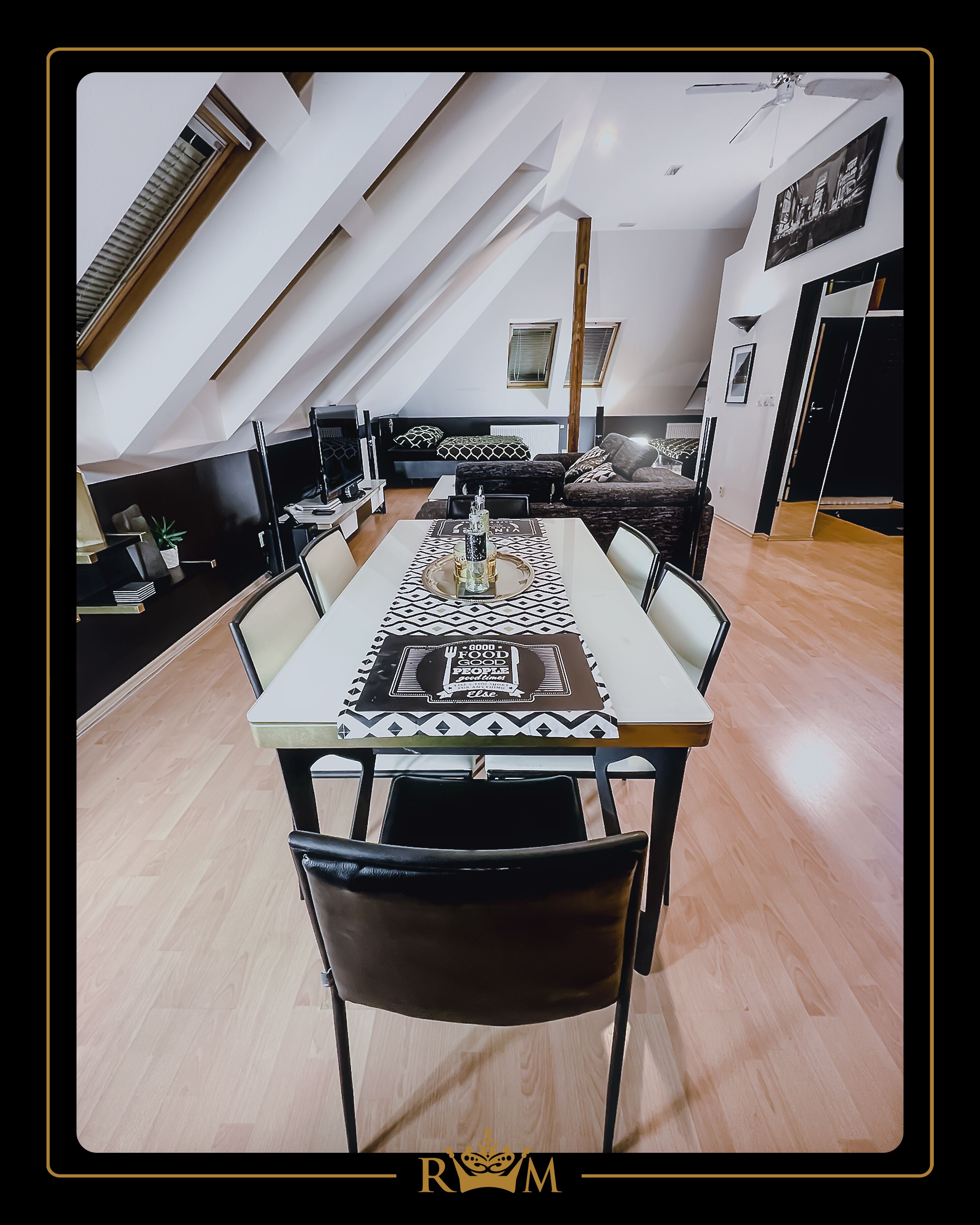 A dining area with a long table, chairs, and a decorative table runner.
