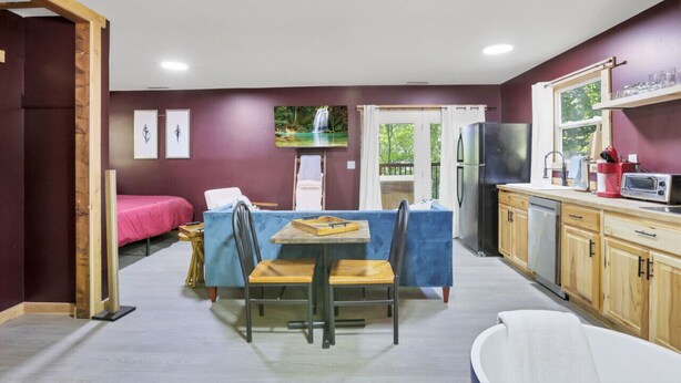 A compact kitchen with a dining area, a refrigerator, a microwave, and a sink. - Gentle Breeze: The Maple: Romantic Secluded Getaway (Lancaster)
