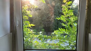 A window with a view of greenery and a kitchen sink with a faucet. - Holiday Home 'Casa Azul' with Mountain View, Shared Pool and Wi-Fi (Moledo)