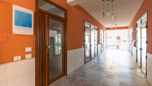 A corridor with glass doors, a sign for Azzurra Balestrate Apartments, and a tiled floor. - Holiday Apartment 'Appartamento A Pigna' with Balcony, Wi-Fi and Air Conditioning (Balestrate)