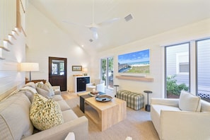 A spacious living room with a high ceiling, a ceiling fan, a large window with a beach view, a fireplace, and a cozy seating area. - Brand-New Luxury Renovation in Seaside; 2 King Suites; Designer Kitchen (Santa Rosa Beach)