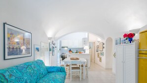 A modern apartment with a living room, kitchen, and dining area.