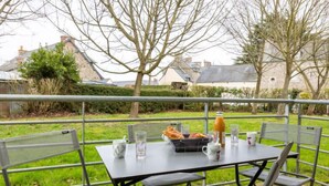 An outdoor dining area with a table set for two, surrounded by metal chairs. - Les Caps Horniers by Interhome (Pleurtuit)