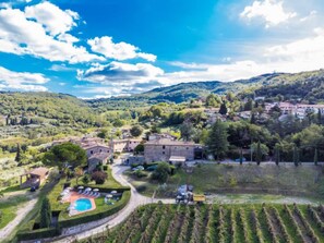 A rural village with stone buildings, a swimming pool, and terraced vineyards. - Colombaia + Aia by Interhome (Greve in Chianti)