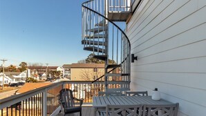 A balcony with a spiral staircase, outdoor furniture, and a view of the neighborhood. - IN THE HEART OF DEWEY BEACH - 2002 Bayard Ave (Dewey Beach)