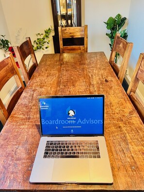 A wooden dining table with a laptop displaying a website. - BATH AND BRISTOL 9 MIN BY TRAIN - in Conservation Area (Bath & NE Somerset)