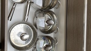 A kitchen drawer with various stainless steel kitchen utensils and pots. - A 10km de Bxl ,2ch, Pour 7 ,parck,meublé,bus,train (Asse)