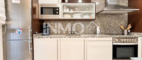 A modern kitchen with stainless steel appliances, a microwave, and a built-in oven.