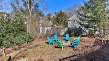 A backyard with outdoor seating and a staircase leading to a house.