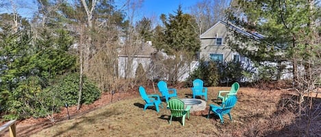 A backyard with outdoor seating and a staircase leading to a house.