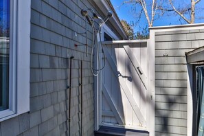 A house with a visible exterior water spigot and a door leading to a covered porch. - Contemporary Saltbox In New Seabury! (Mashpee)