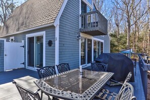 A two-story house with a deck, a barbecue grill, and outdoor seating. - Contemporary Saltbox In New Seabury! (Mashpee)