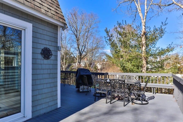 A deck with outdoor furniture and a grill. - Contemporary Saltbox In New Seabury! (Mashpee)