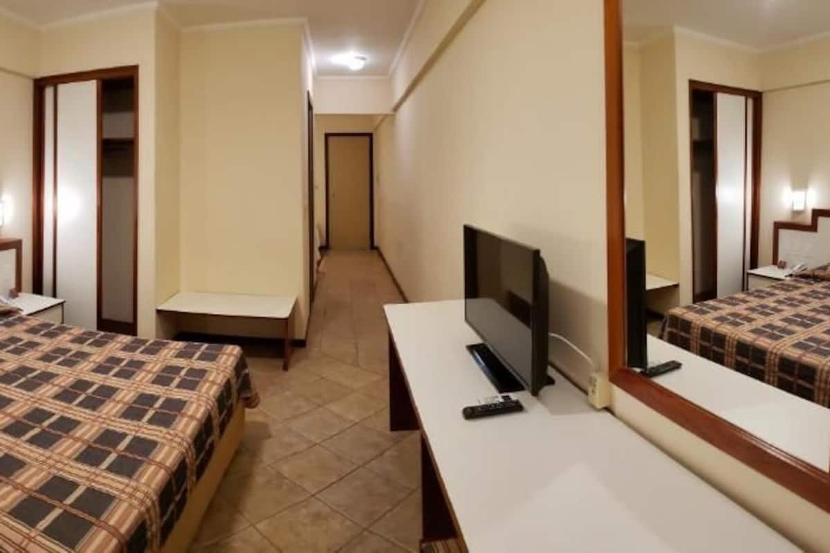 Familiekamer | Een minibar, een bureau, een laptopwerkplek, verduisterende gordijnen