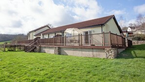 A two-story house with a balcony, a staircase, and a stone foundation. - Greenfields - UK43269 (Upottery, near Honiton)