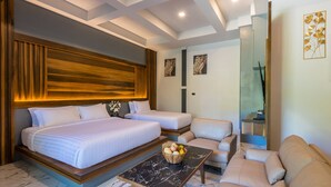 A modern hotel room with two beds, a sofa, a marble coffee table, and a wall-mounted TV. - Loy Chalet (Krabi)