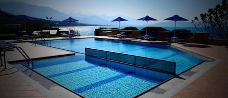 Seasonal outdoor pool, pool umbrellas, pool loungers