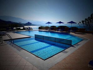 Seasonal outdoor pool, pool umbrellas, sun loungers