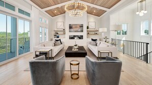 A spacious living room with a high ceiling, large windows, and a balcony. - Grayt Joy|Private Community Beach Access|Unobstructed Gulf Views (Santa Rosa Beach)