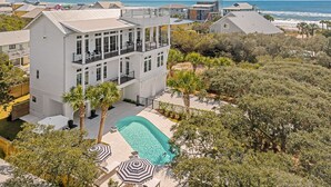 A large, multi-story building with a swimming pool and outdoor seating area. - Grayt Joy|Private Community Beach Access|Unobstructed Gulf Views (Santa Rosa Beach)