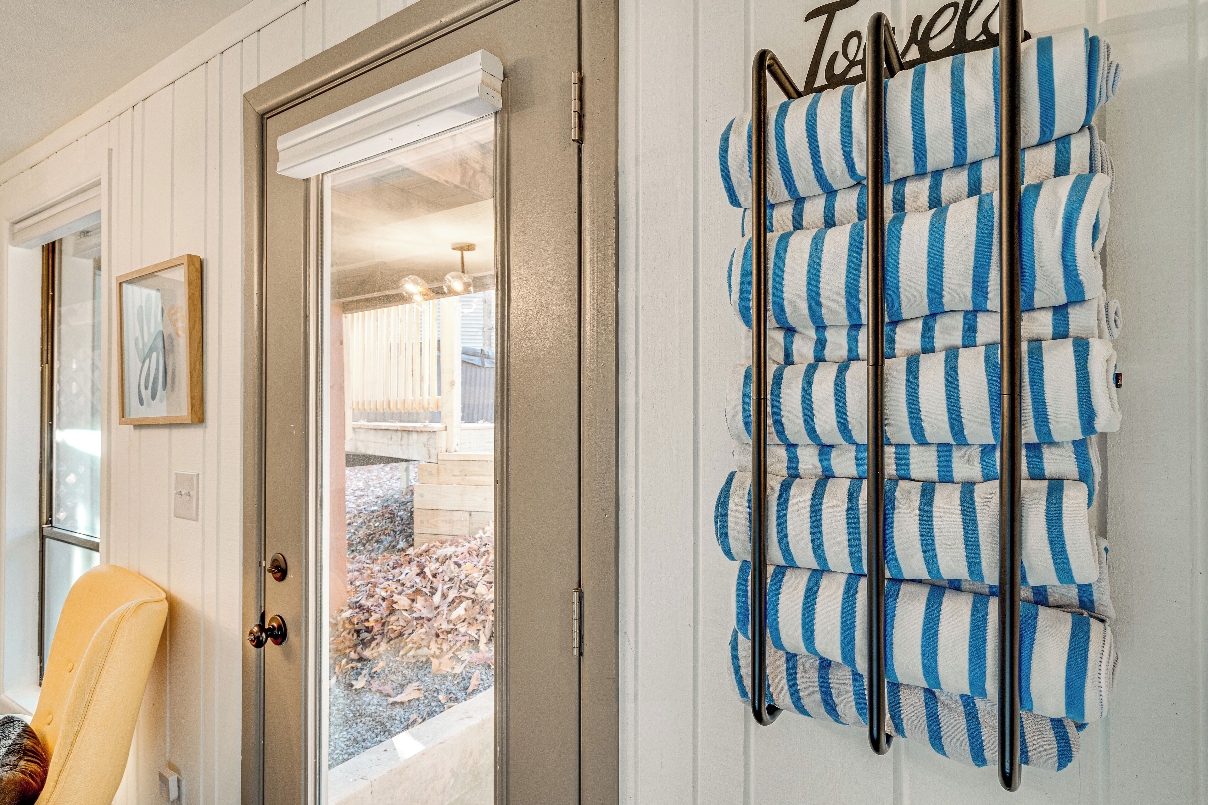 A door with a towel rack holding striped towels.