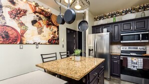 A modern kitchen with granite countertops, stainless steel appliances, and a large world map mural. - 10 Seat Home theater. Office. Step-Free Entry. Seniors Welcomed. Pet Friendly! (Jim Thorpe)