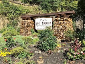 Escape to a serene natural oasis at Smoky Mountain Retreat, surrounded by lush gardens and a rustic charm.