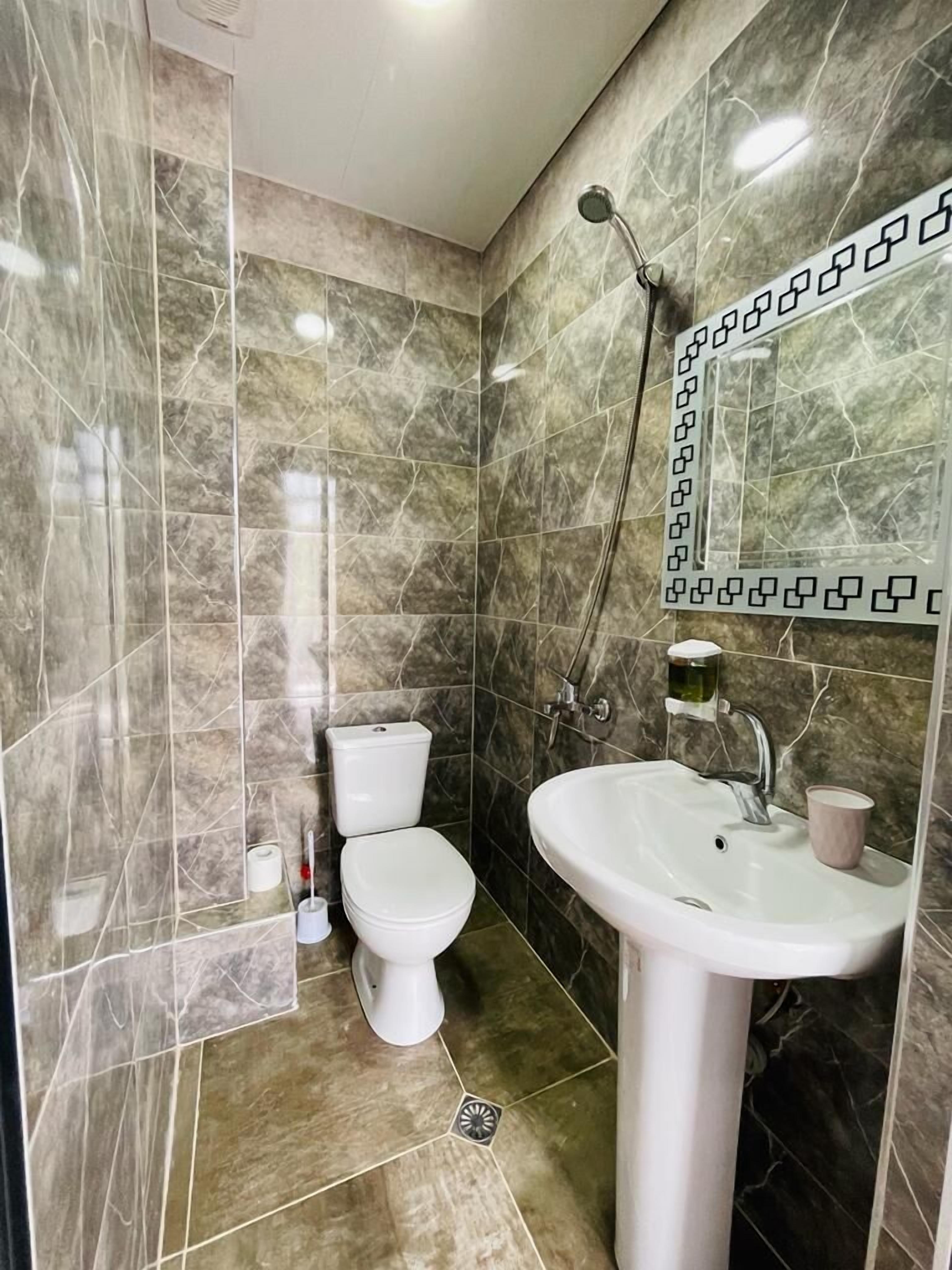 Shower, hair dryer, slippers, towels