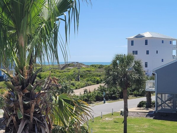 A coastal view with a white building, palm trees, and a clear sky. - Dog-Friendly End Unit· Gulf Views· 1 Min to Beach (Port St. Joe)