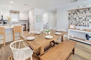 Enjoy meals in this stylish dining area with a table for six and a wall-mounted display of plates.