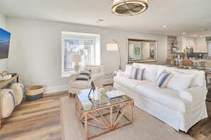 Relax in this stylish living room with a sofa, coffee table, and rug.