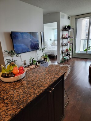 Relax in a stylish living space with a flat-screen TV, comfortable seating area, and dining area with a granite countertop.