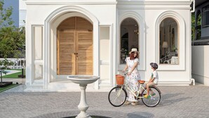 A two-story house with a central entrance, a circular driveway, and a small garden with a fountain. - Arpo Pool Villa Riverside Bangkok | 3-Bedroom Private Villa Near MRT & Iconsiam (Bangkok)