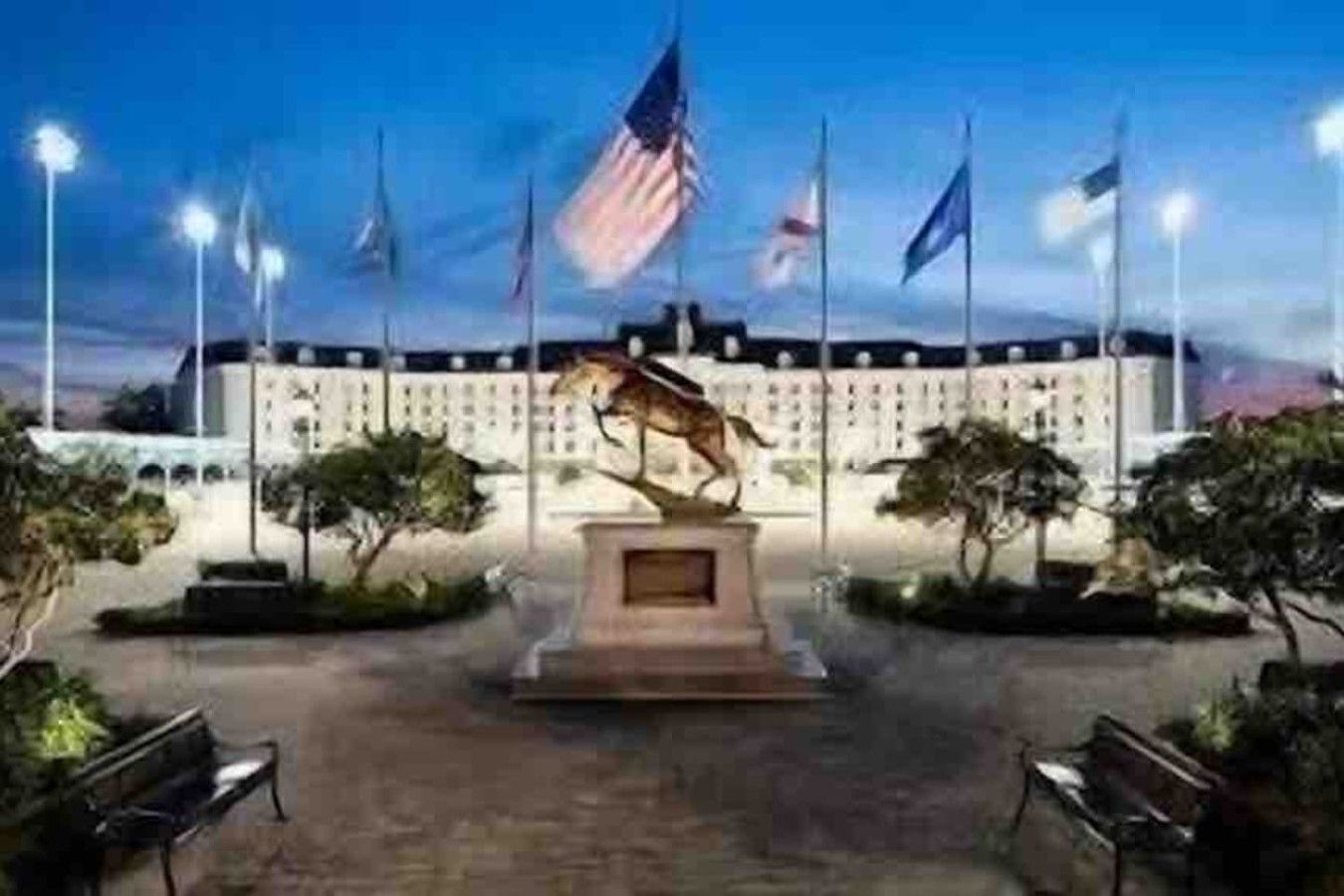 A building with a central flagpole, a statue, and a flag.