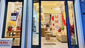 A hotel entrance with a sign reading "Sunrise Homestay Together We Rise". - SUNRISE Hotel Bac Lieu (Bac Lieu)