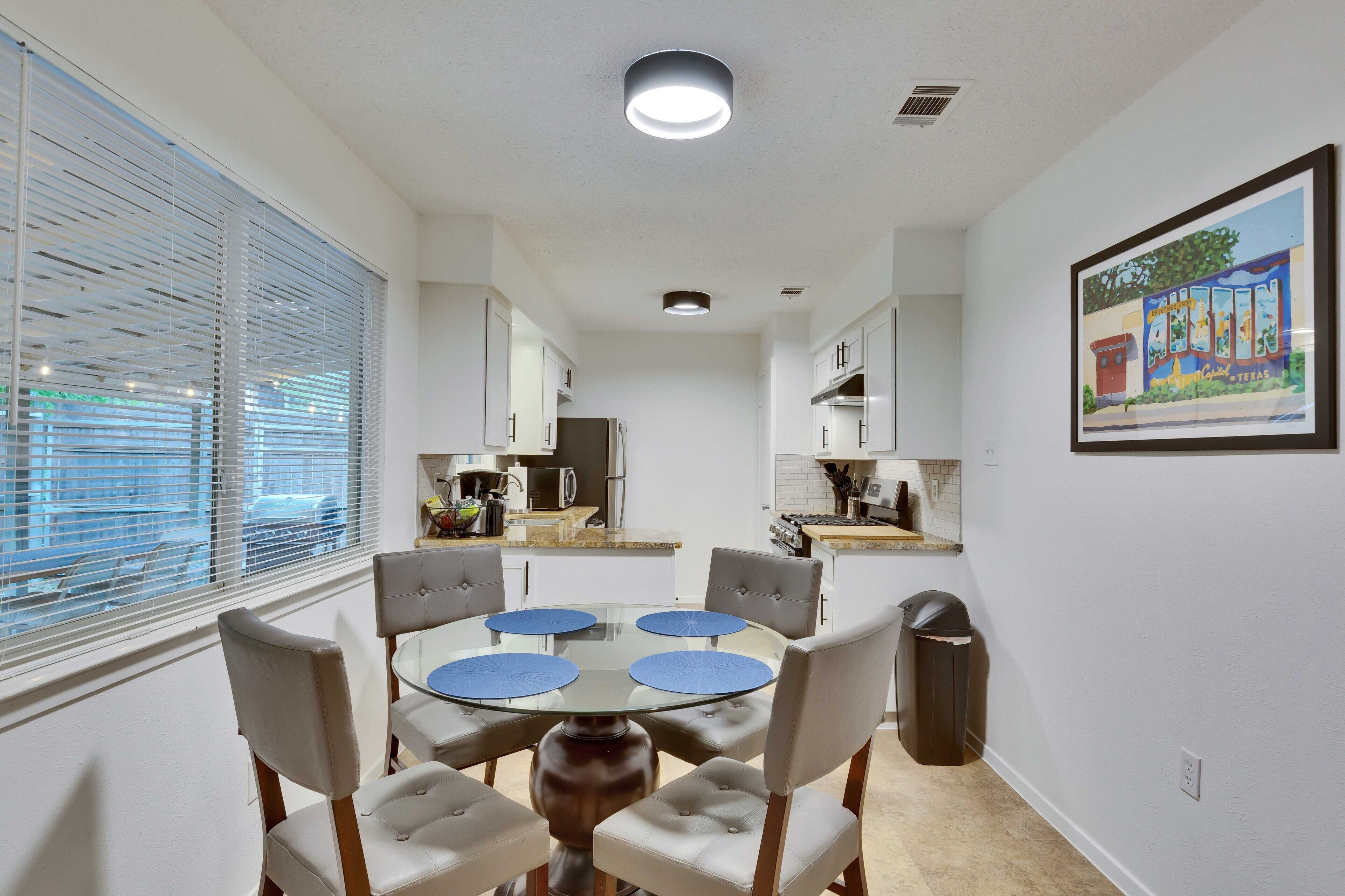 A compact kitchen with white cabinets, a microwave, and a stove.